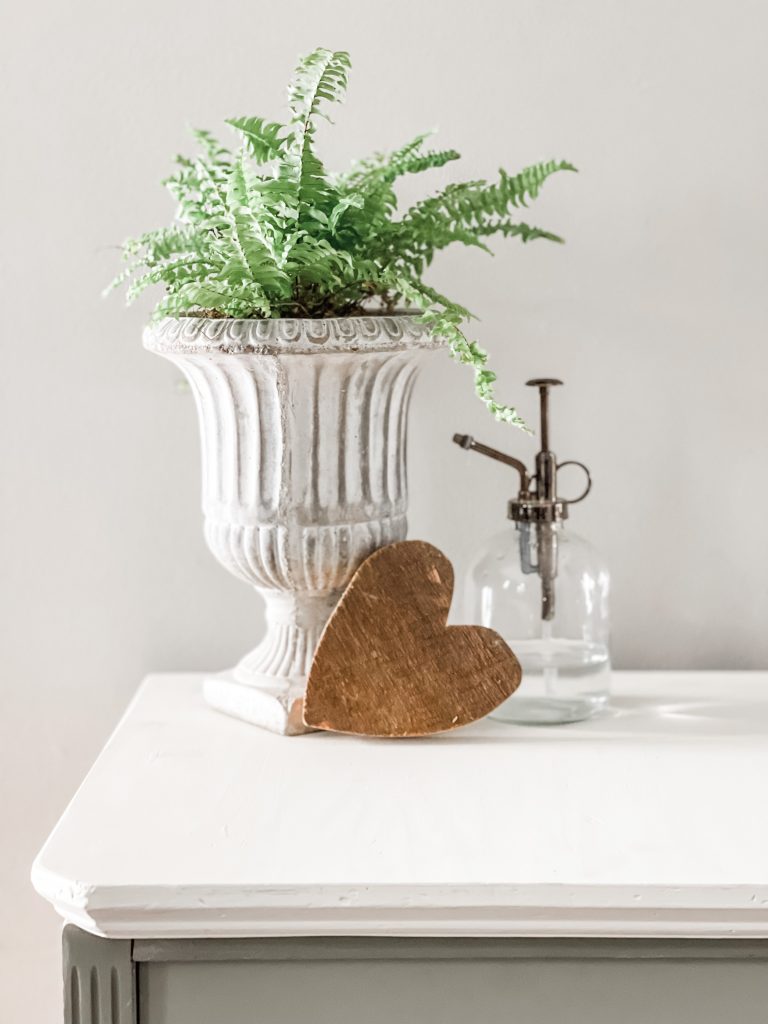 top of revamped hutch with a plant and heart on top