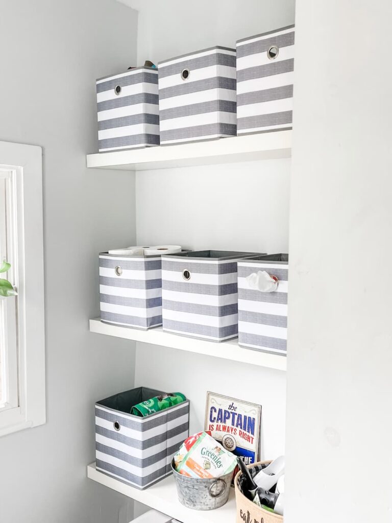 grey and white cube containers from target on shelves in mud room
