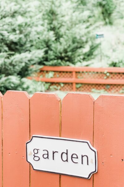 garden sign on red fence