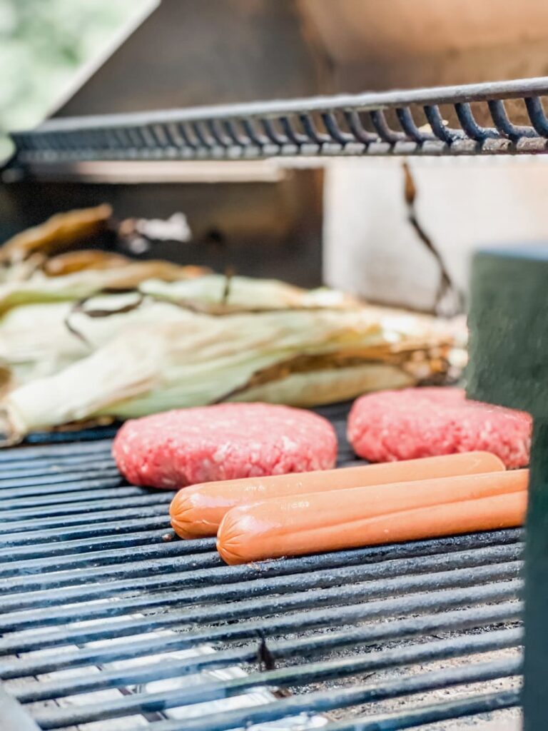 burgers and dogs on grill