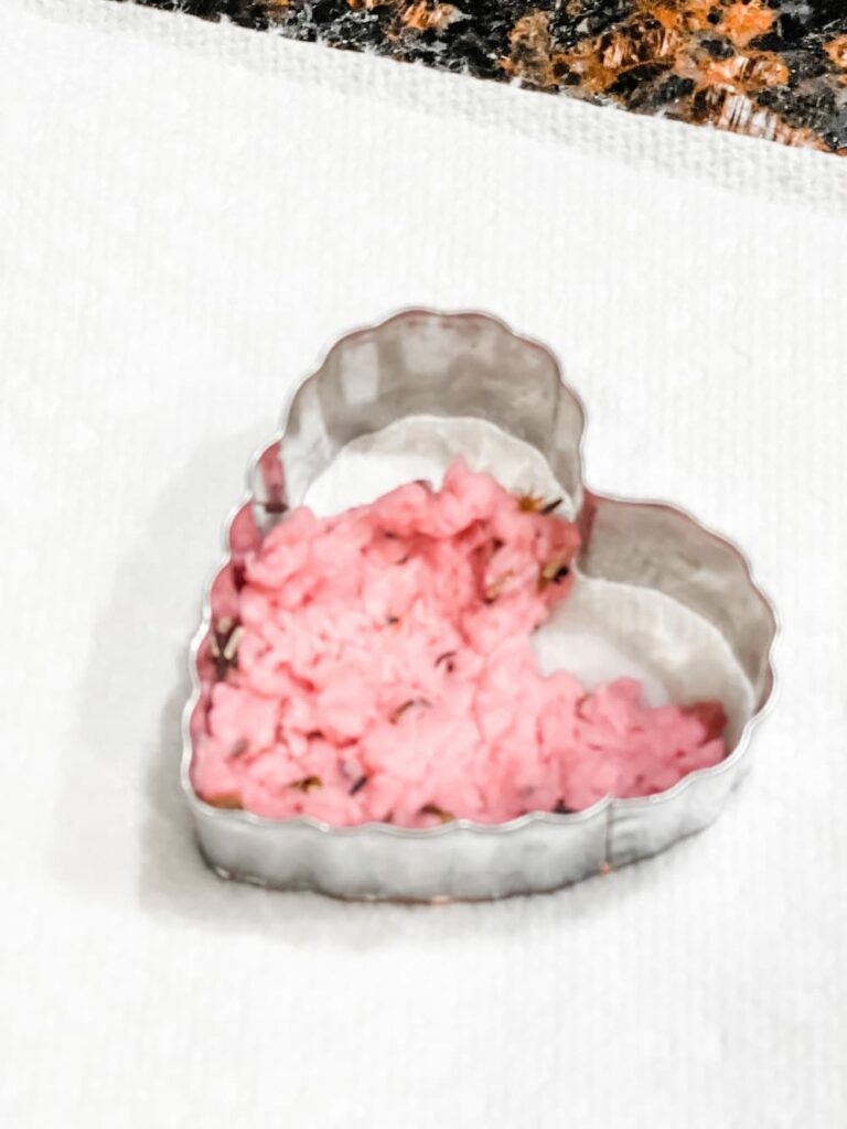 wet seed paper inside a heart cookie cutter