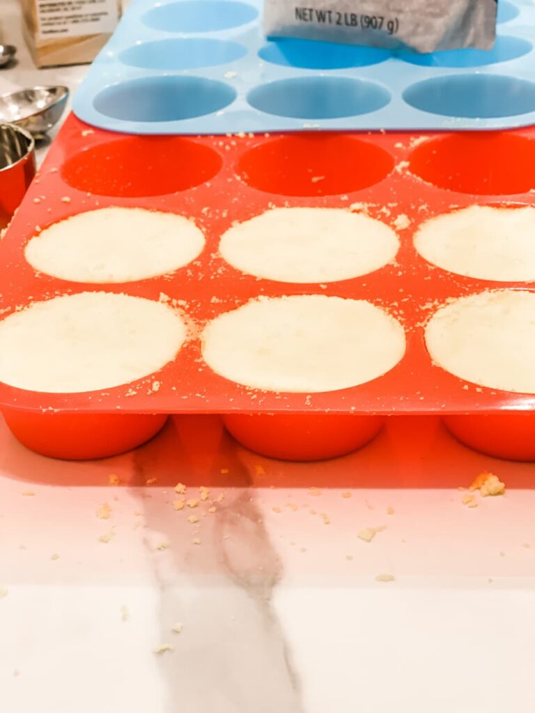 A RED SILICON MOLD WITH YELLOW SHOWER MELTS INSIDE