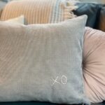 grey pillow with pink embroidered xo