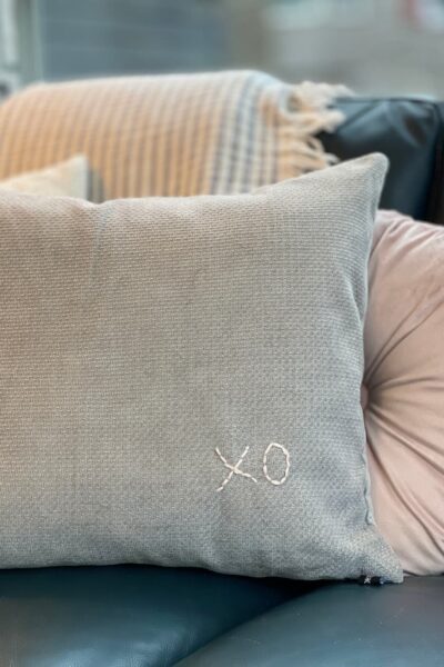 grey pillow with pink embroidered xo