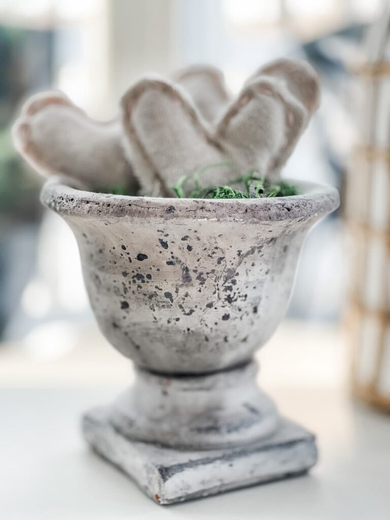 STONEWARE PEDESTAL VASE WITH 3 DROP CLOTH STITCHED HEARTS