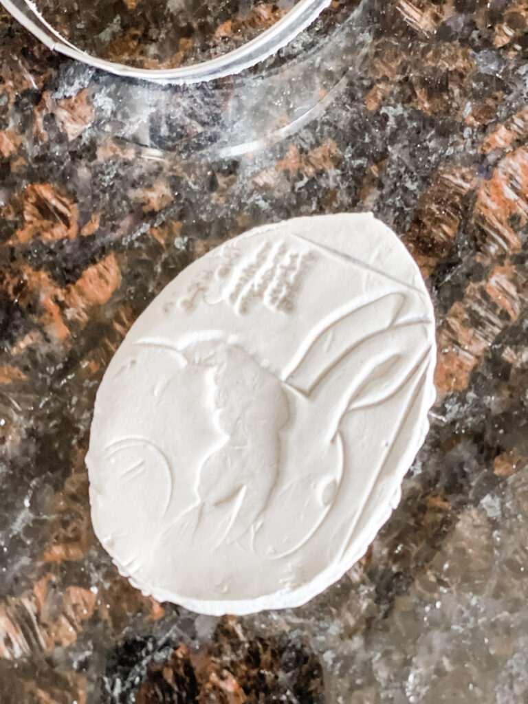 WHITE CLAY EGG STAMPED WITH A BUNNY