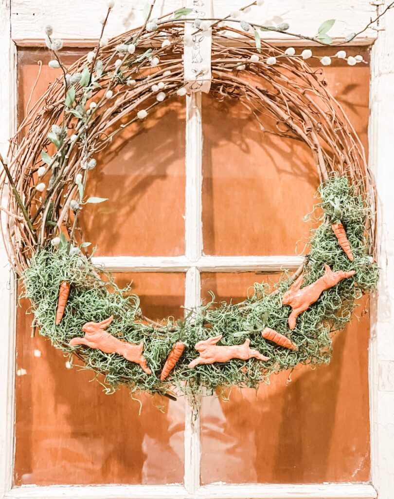 GRAPEVINE WREATH ON VINTAGE WINDOW WITH CLAY BUNNIES AND PUSSY WILLOW ATTACHED