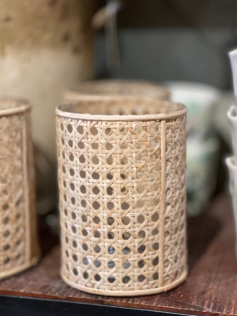 a round vase with caning material around it