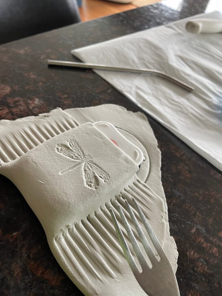 fluting the edges of air dry clay with a fork