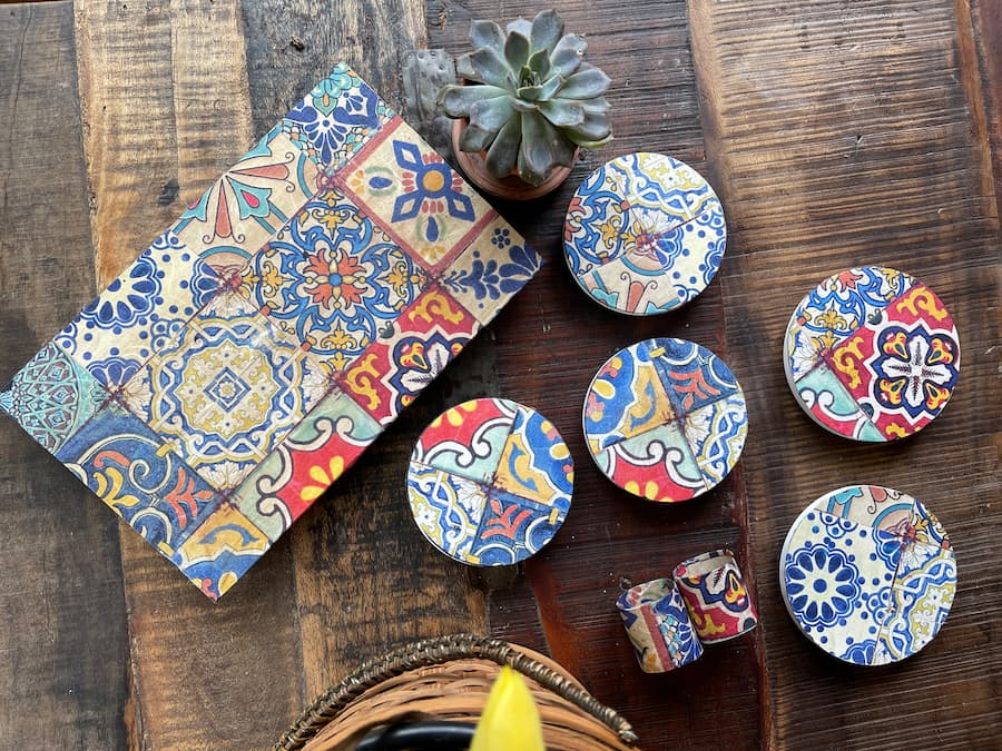 5 wooden candle lids covered with a festive rice paper to create coasters and trivets