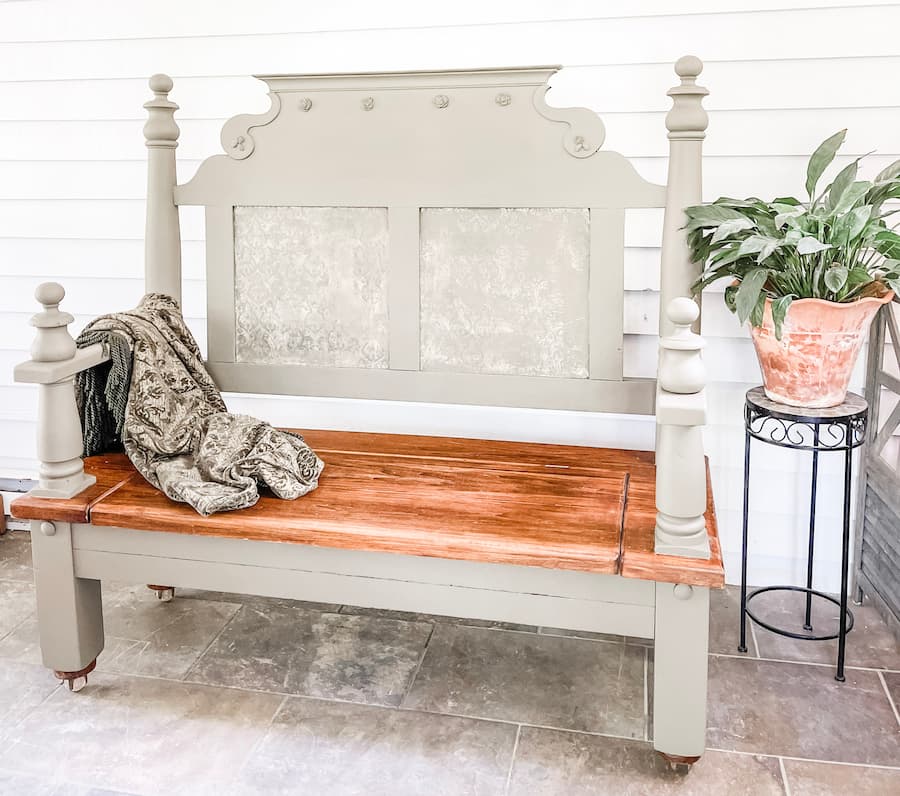 vintage headboard bench  staged with a blanket and plant