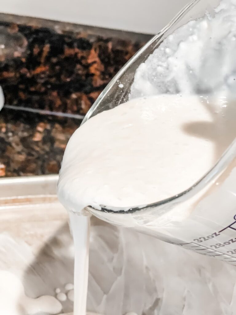 POURING PANCAKE MIX ONTO SHEET PAN