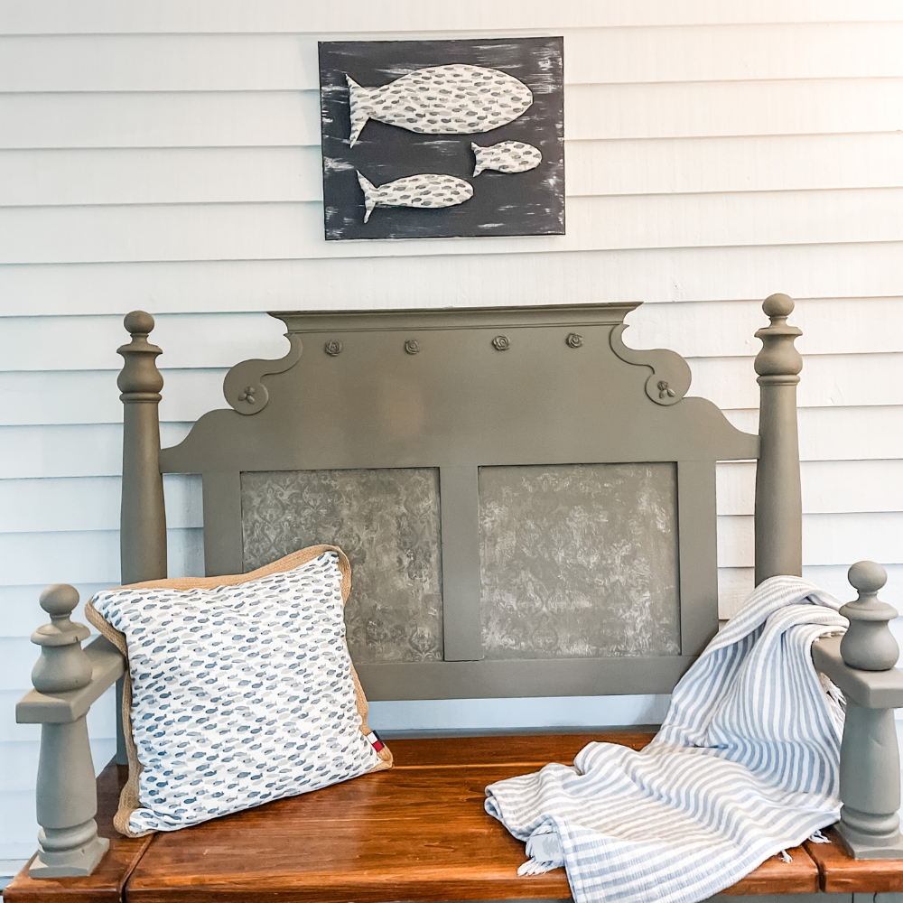 bench with fish fabric wall art above it
