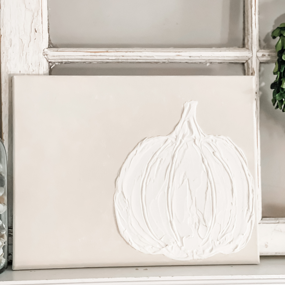PICTURE OF A WHITE PUMPKIN MADE ON CANVAS WITH SPACKLE AND PAINTED CREAM BACKGROUND