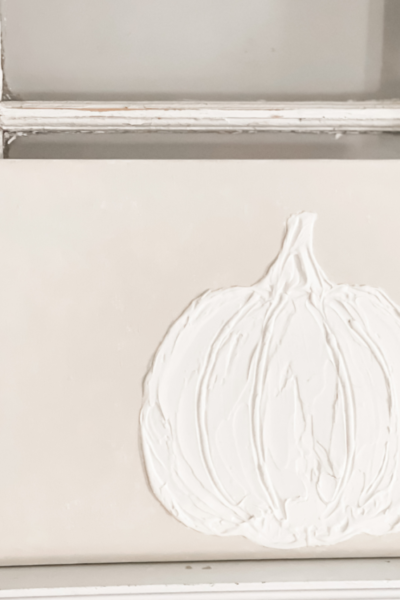 PICTURE OF A WHITE PUMPKIN MADE ON CANVAS WITH SPACKLE AND PAINTED CREAM BACKGROUND