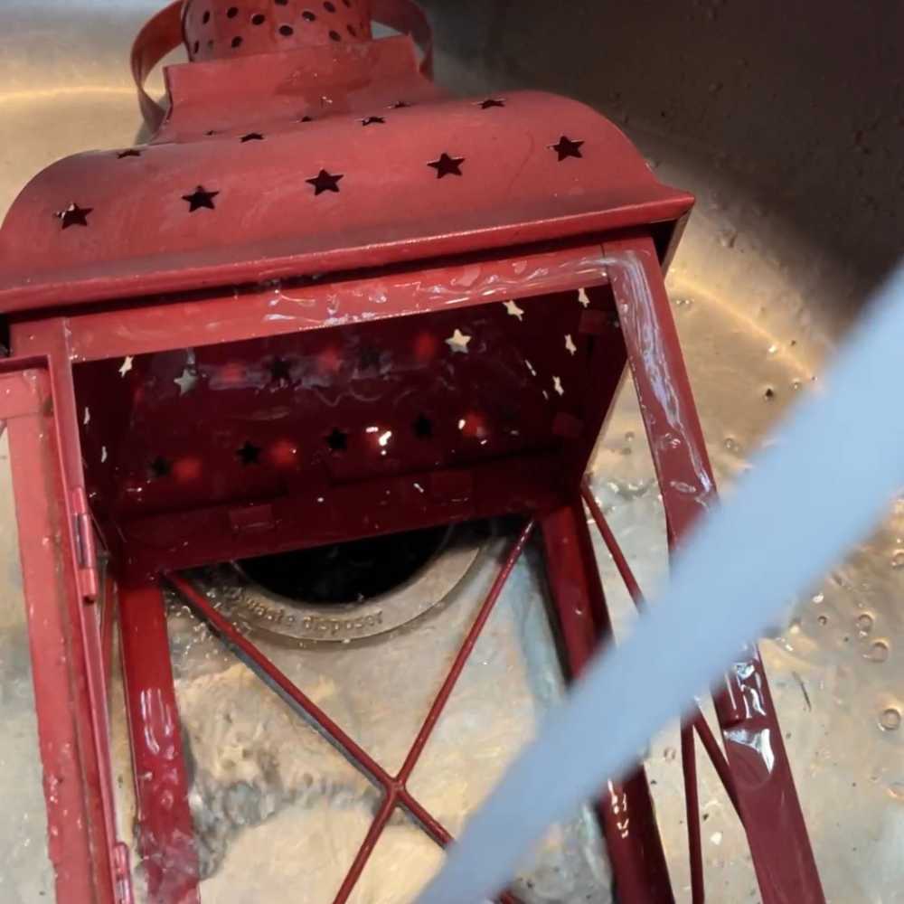 WASHING THE LANTERN IN THE SINK