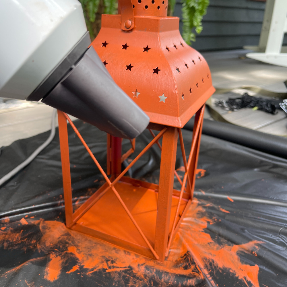 using a hair dryer to dry the primer on the lantern